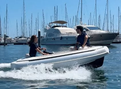 Couple cruising a marina in a tender